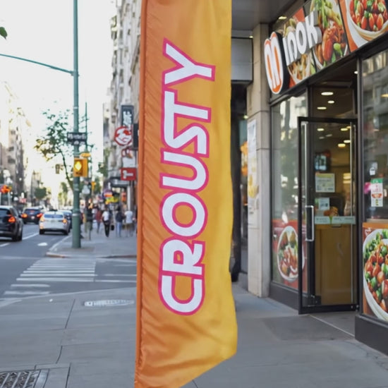 Vidéo de l'oriflamme drapeau publicitaire  rouge et jaune publicitaire 'CROUSTY' de 2m à 6m avec texte en jaune, idéal pour les restaurants spécialisés en street food.